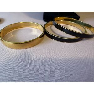 vintage Monet black enamel gold-tone  and gold-tone bangle bracelets.